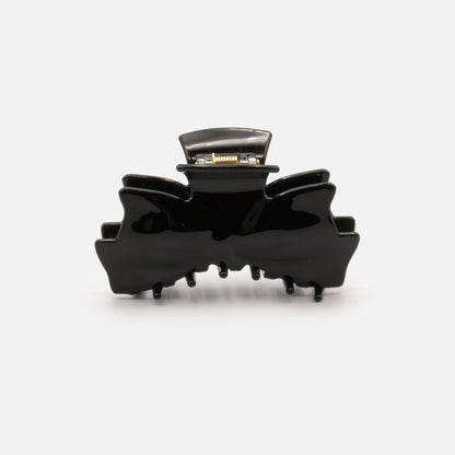 HA253W031BK - Pince noire en forme de boucle en plastique au fini lustré