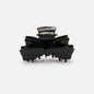 HA253W031BK - Pince noire en forme de boucle en plastique au fini lustré