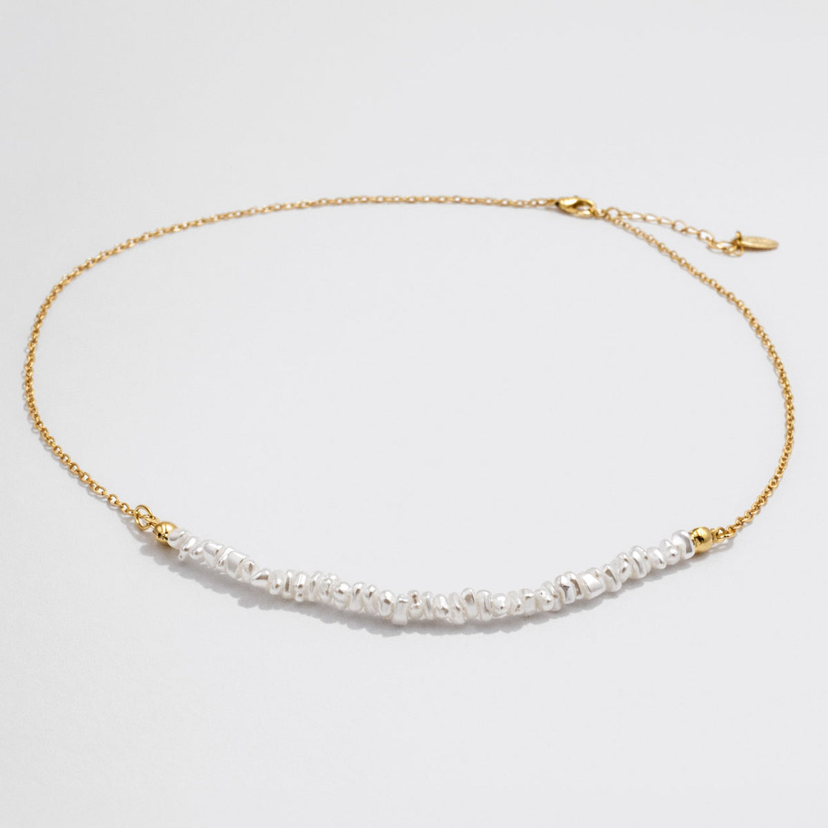 Delicate Golden Necklace with Asymmetric Pearl Row
