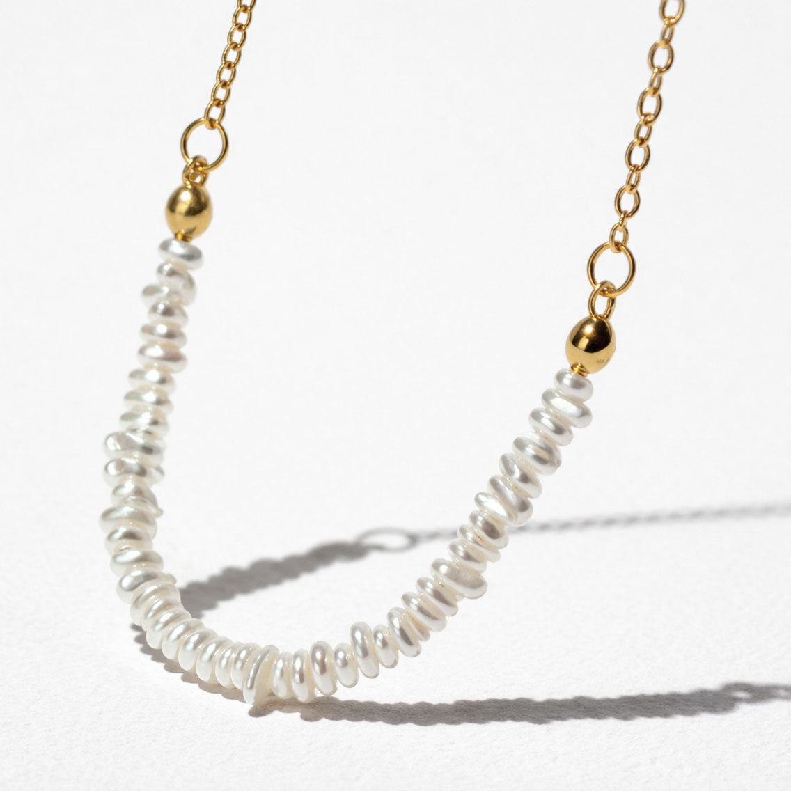 Delicate Golden Necklace with Asymmetric Pearl Row